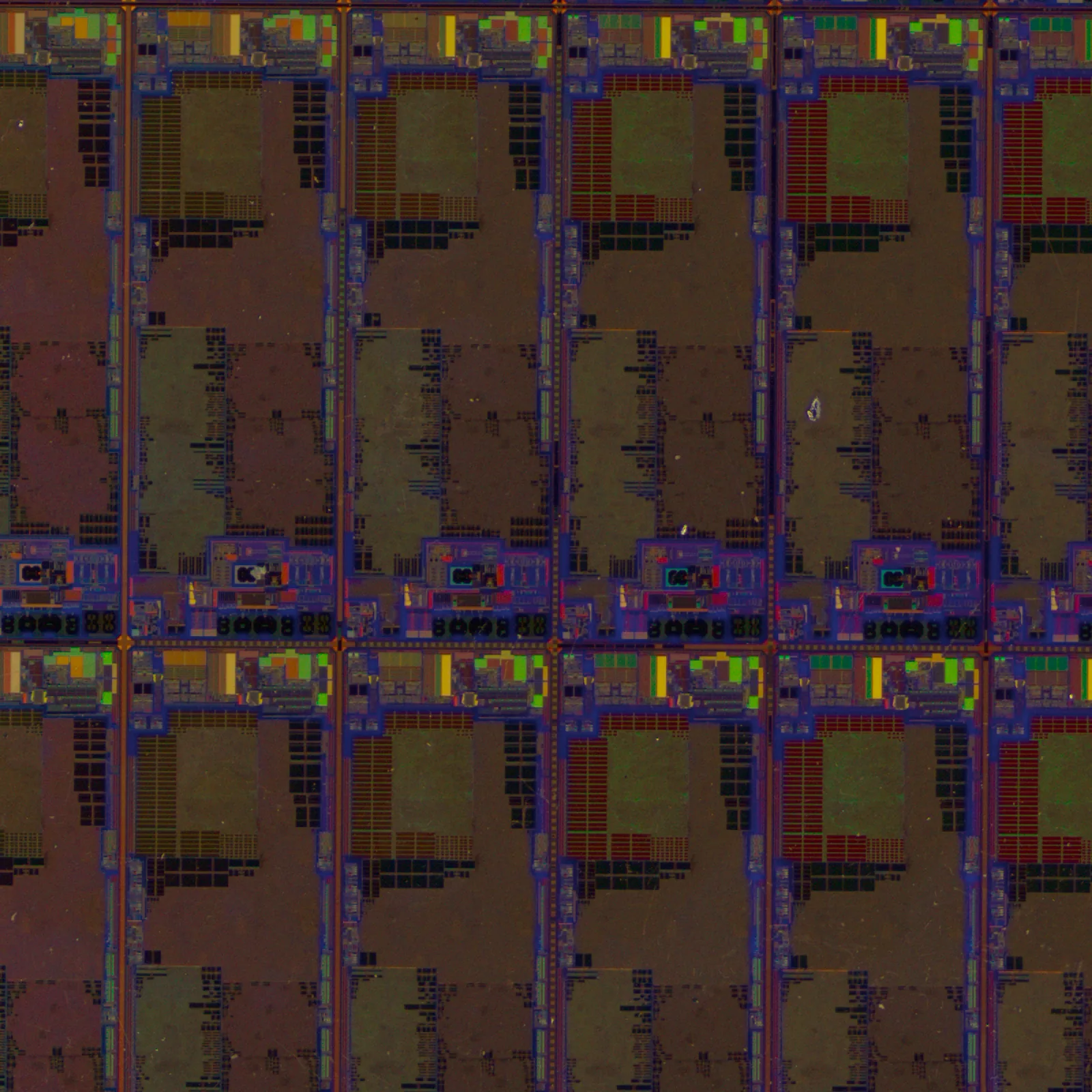 Live image of a semiconductor chip captured with TR-100. Thin-film interference paints it purple, green, red and yellow, and the grid of dies and the fine circuit pattern are lost in the colour.