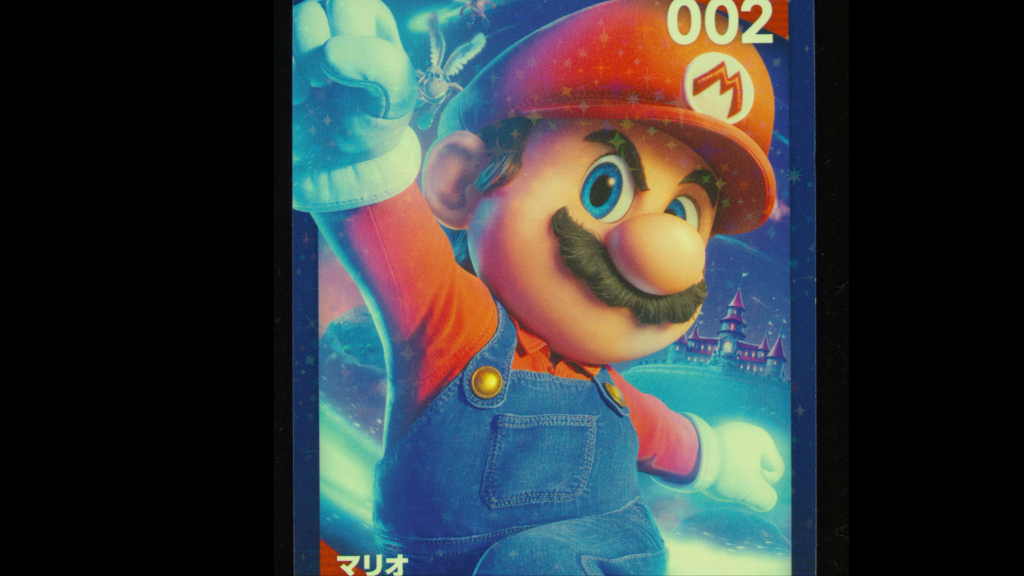 TR-55のライブ画像。カードの絵柄がカラーで写り、全体に星形のキラキラ模様が散っている（© Nintendo）